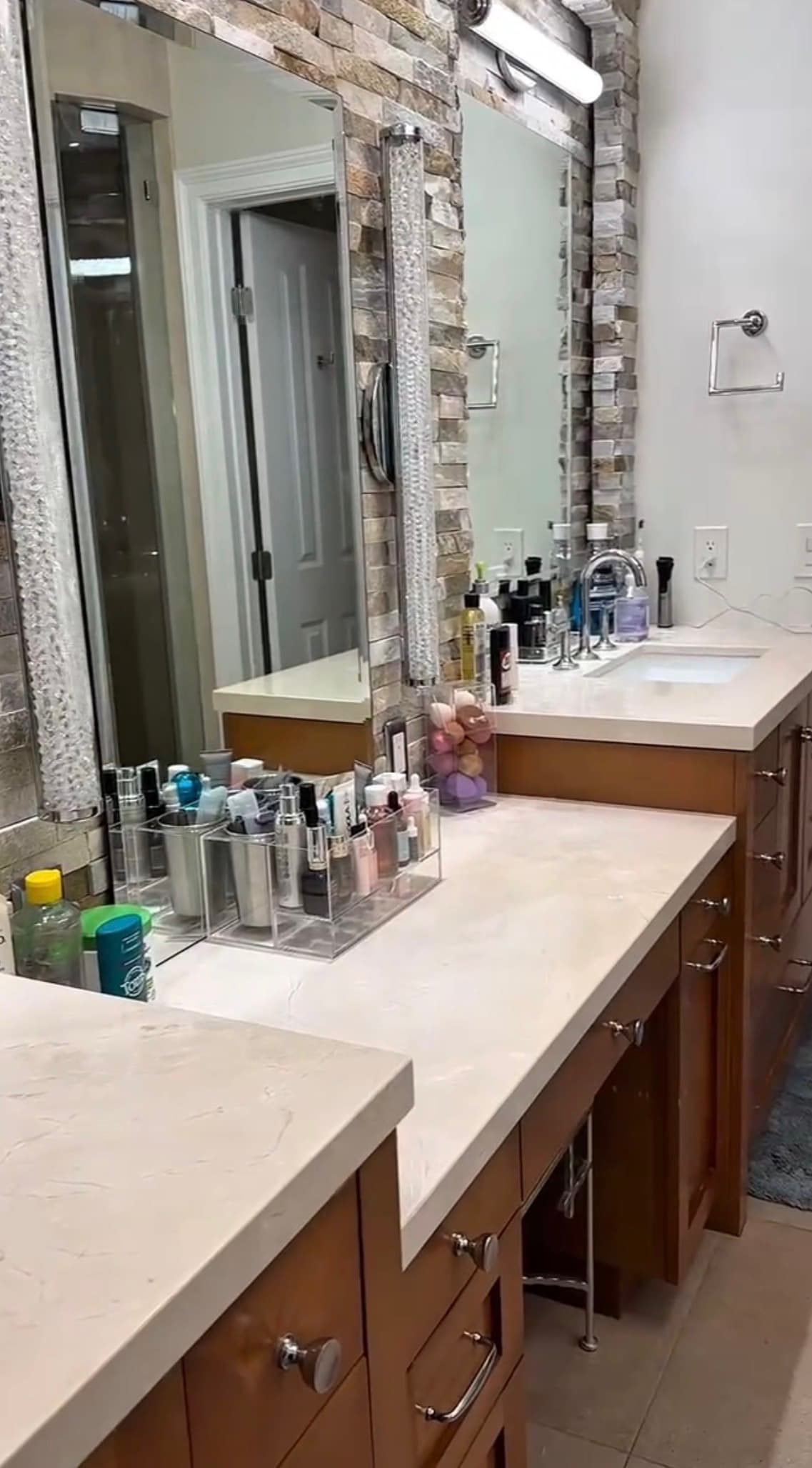 After: the bathroom vanity with clear counters and toiletries grouped in organizers
