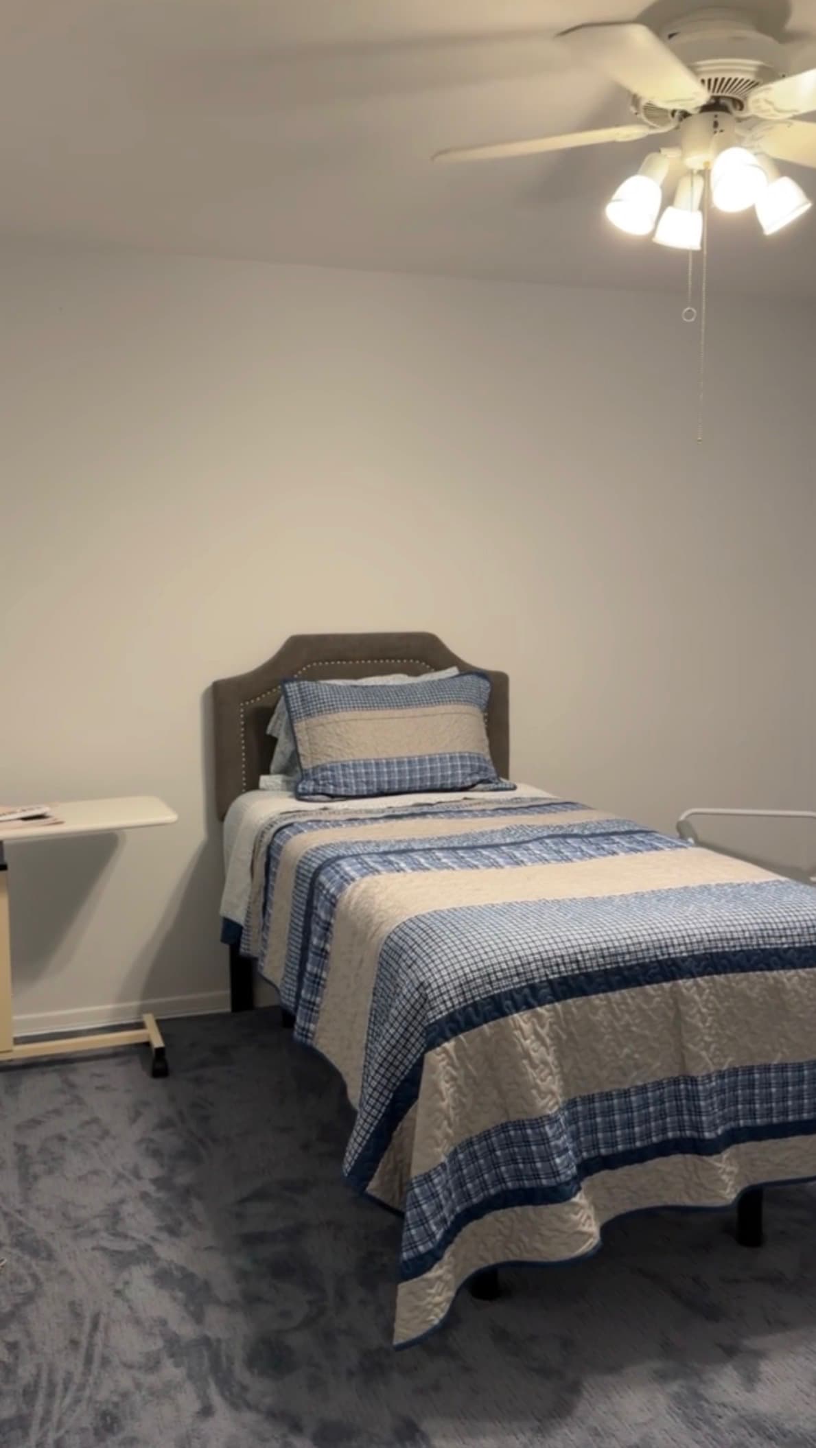 After: the room made into a bedroom with a neatly made bed and open floor space