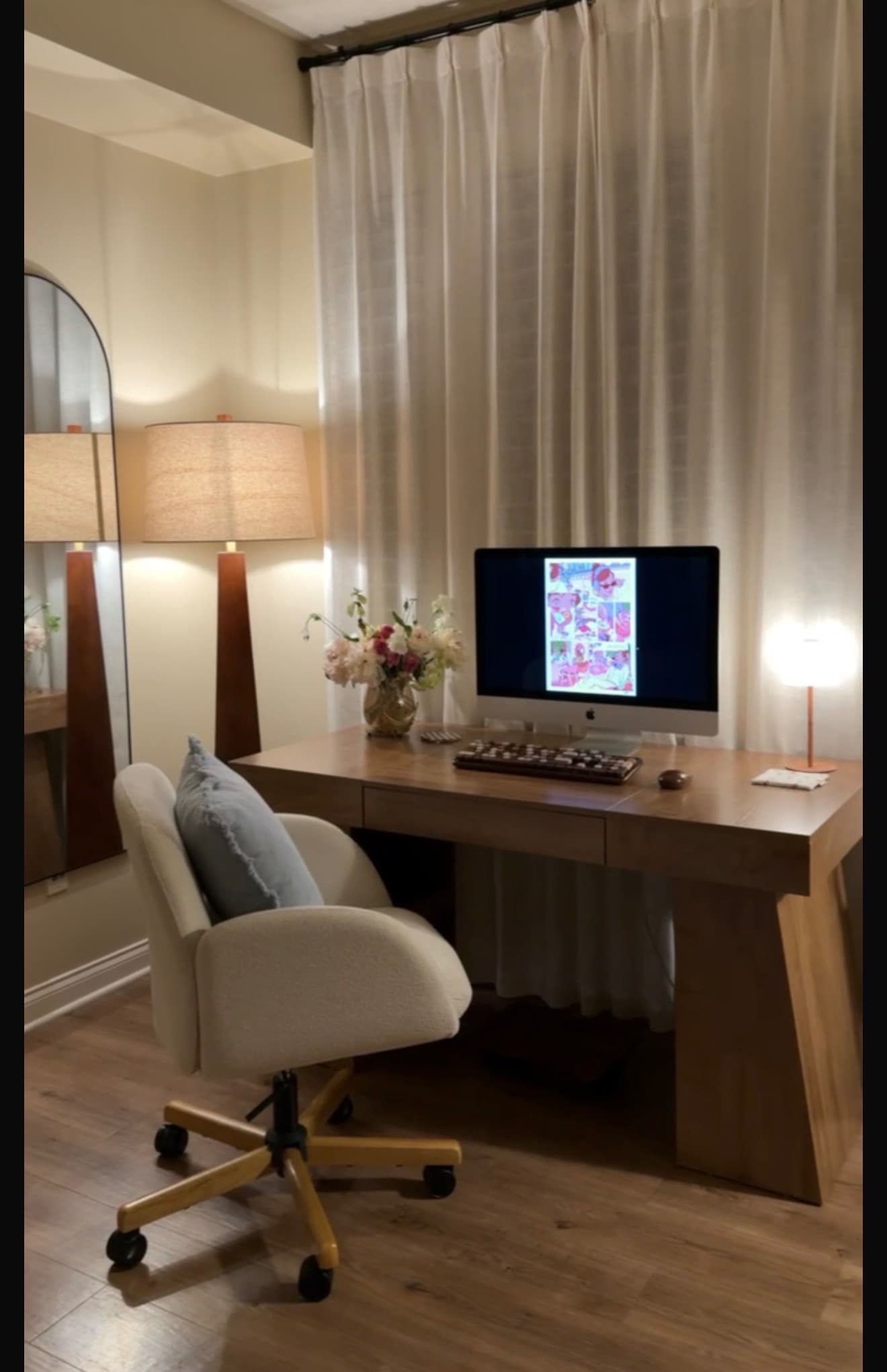 After: a home office with a clear desk, upholstered chair, lamps, and curtains