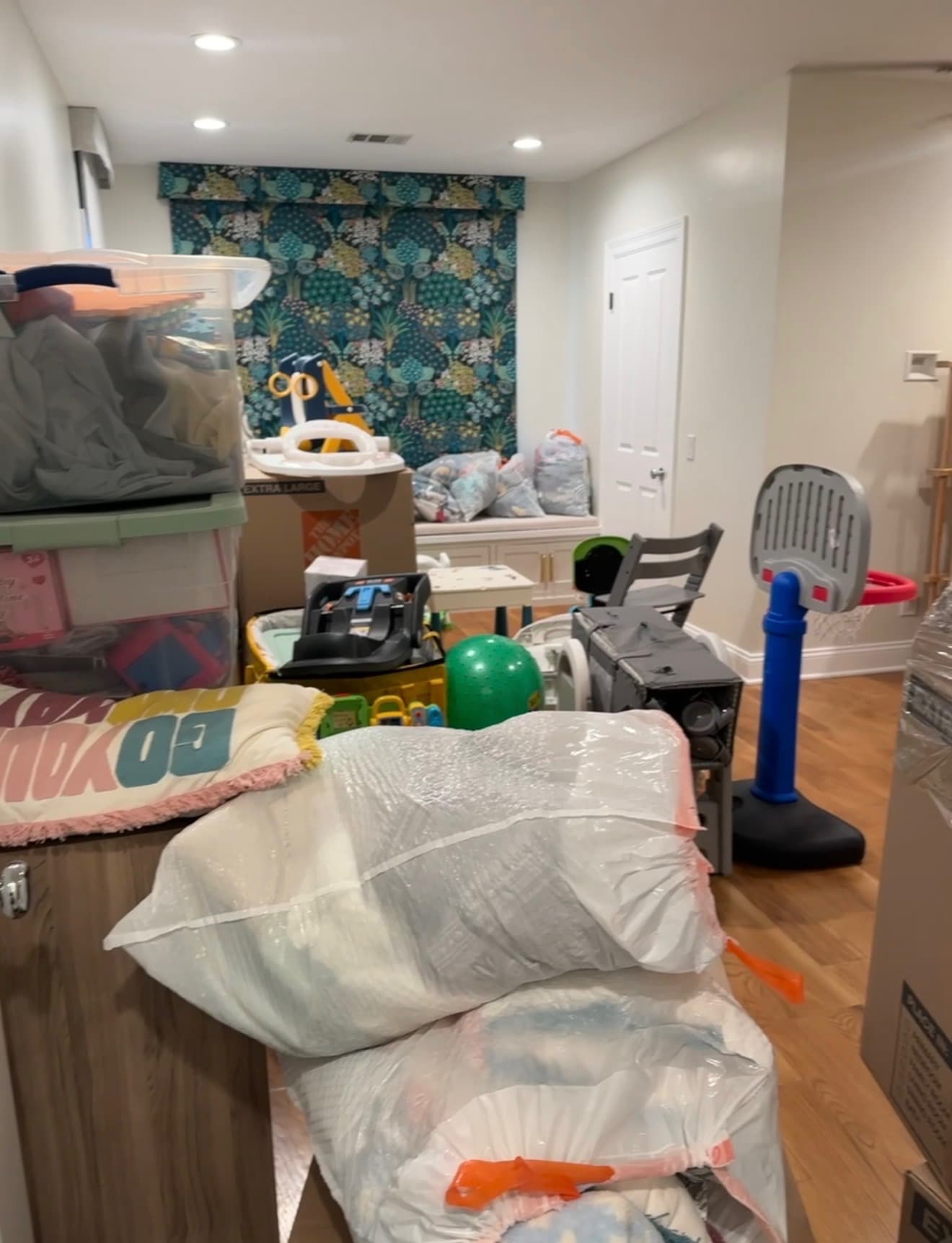 Before: a playroom filled with boxes, toys, and packed belongings