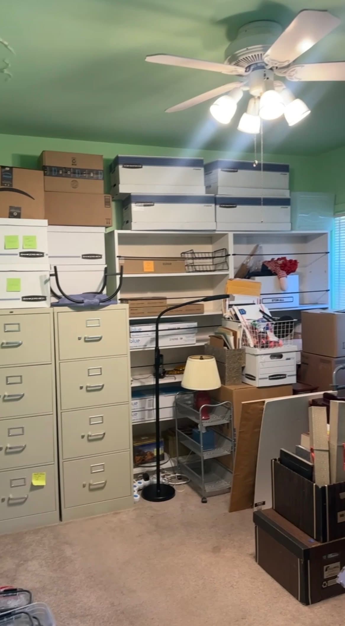 Before: a room filled with stacked boxes and filing cabinets